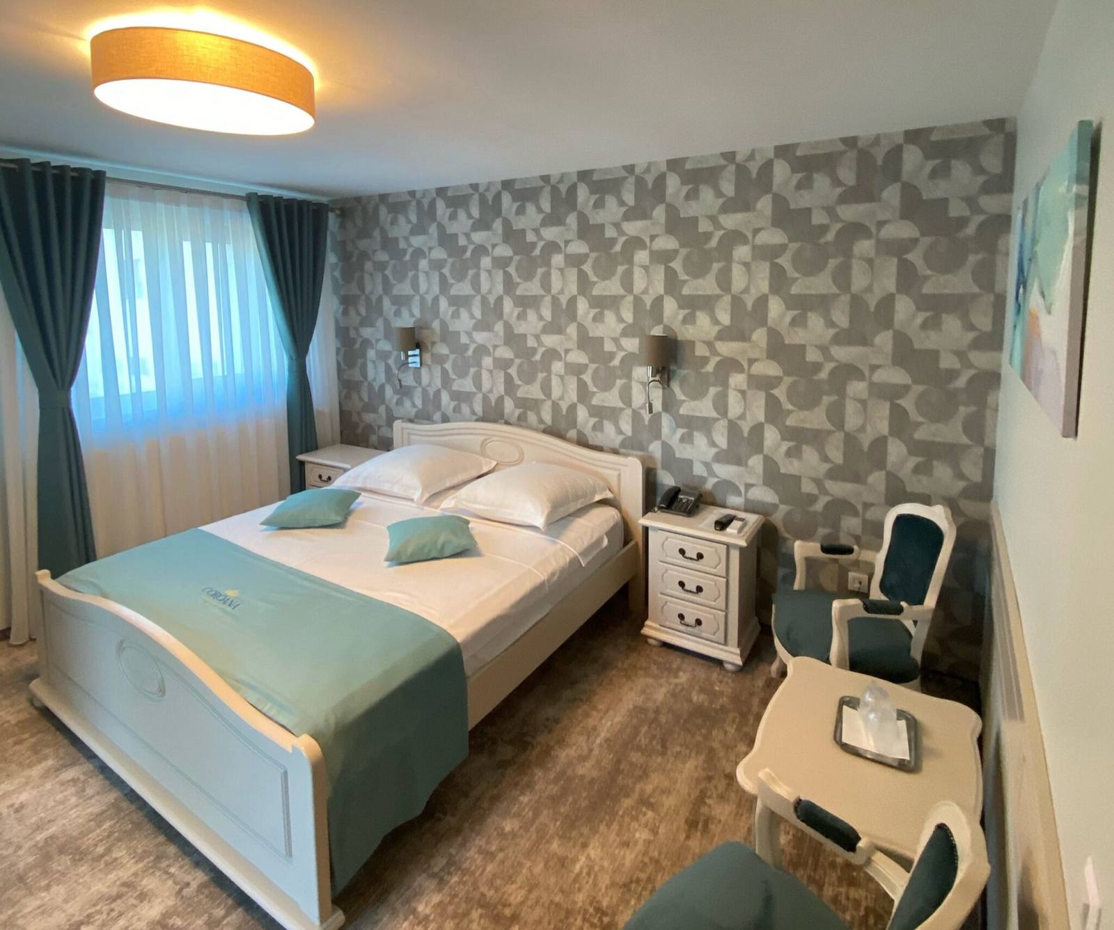 Renovated room — corner with armchair and patterned wallpaper